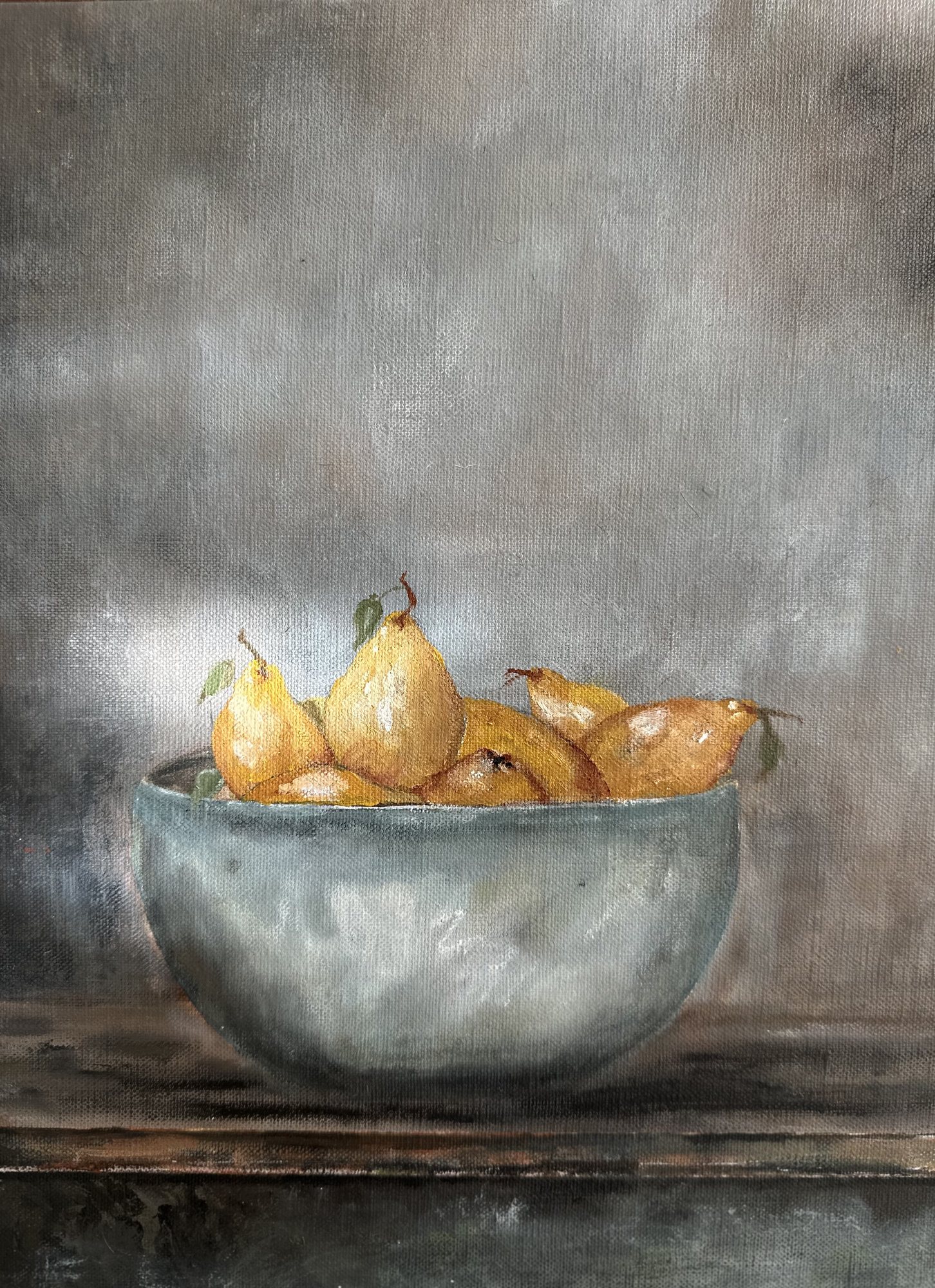 Almost — yellow pears heaped in a pale grey-blue bowl